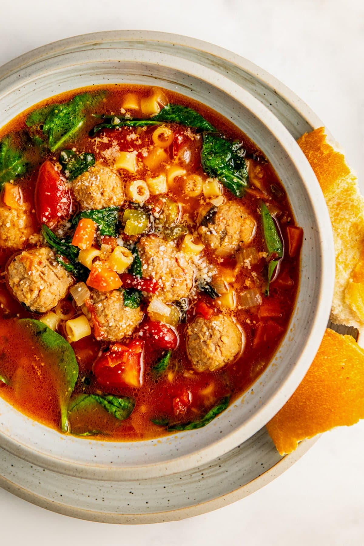 A bowl of hearty Italian wedding soup made easy with frozen meatballs.