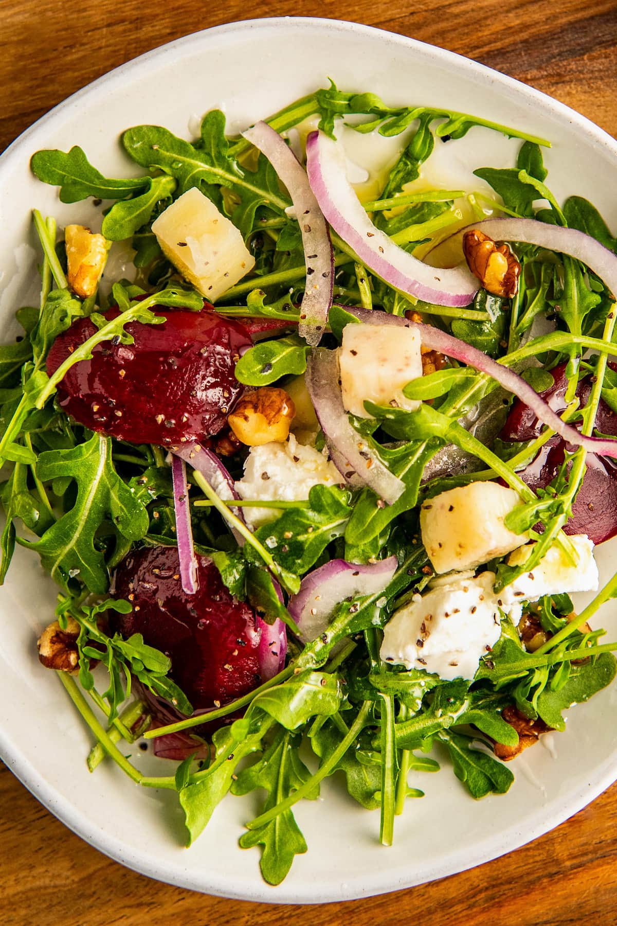 Close up of roasted beet salad on a white plate.