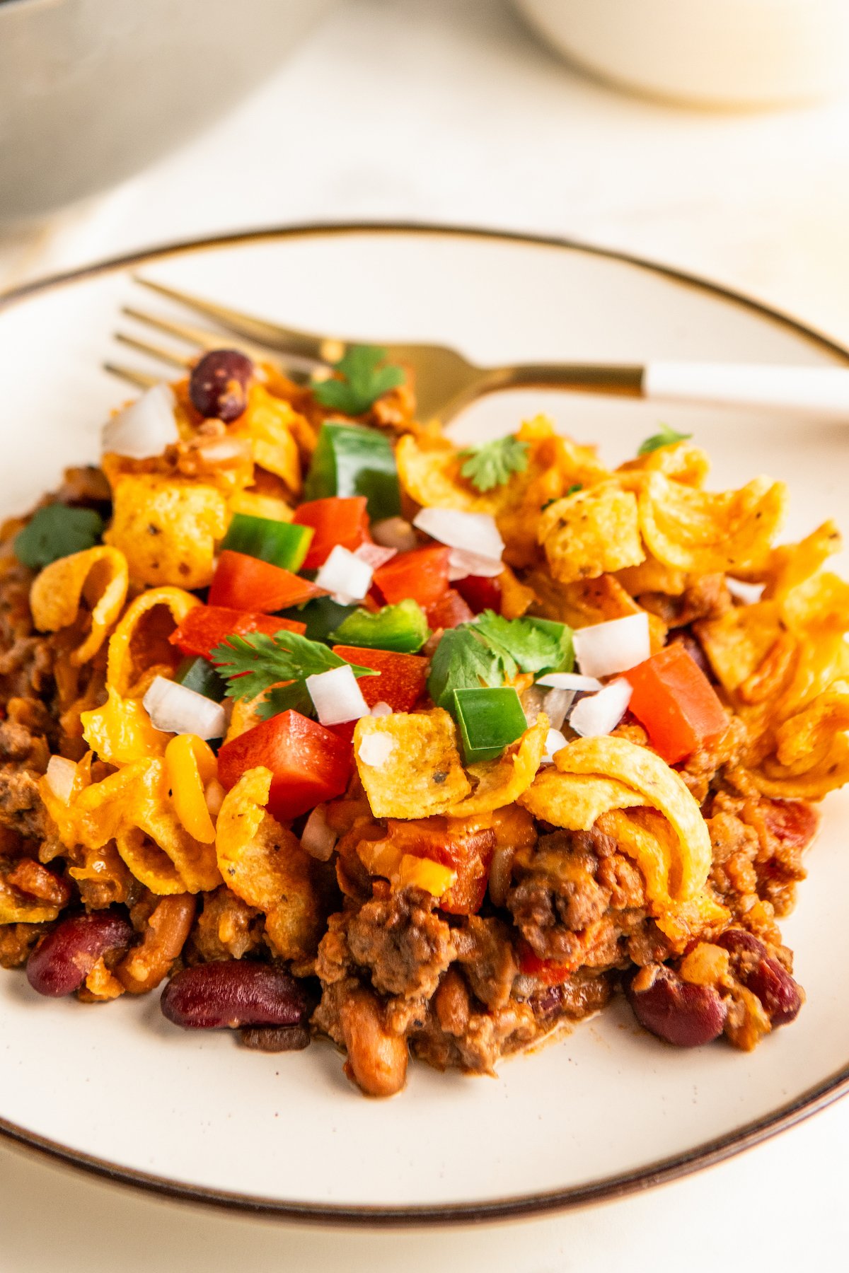 Close up of a plate of Frito chili pie.