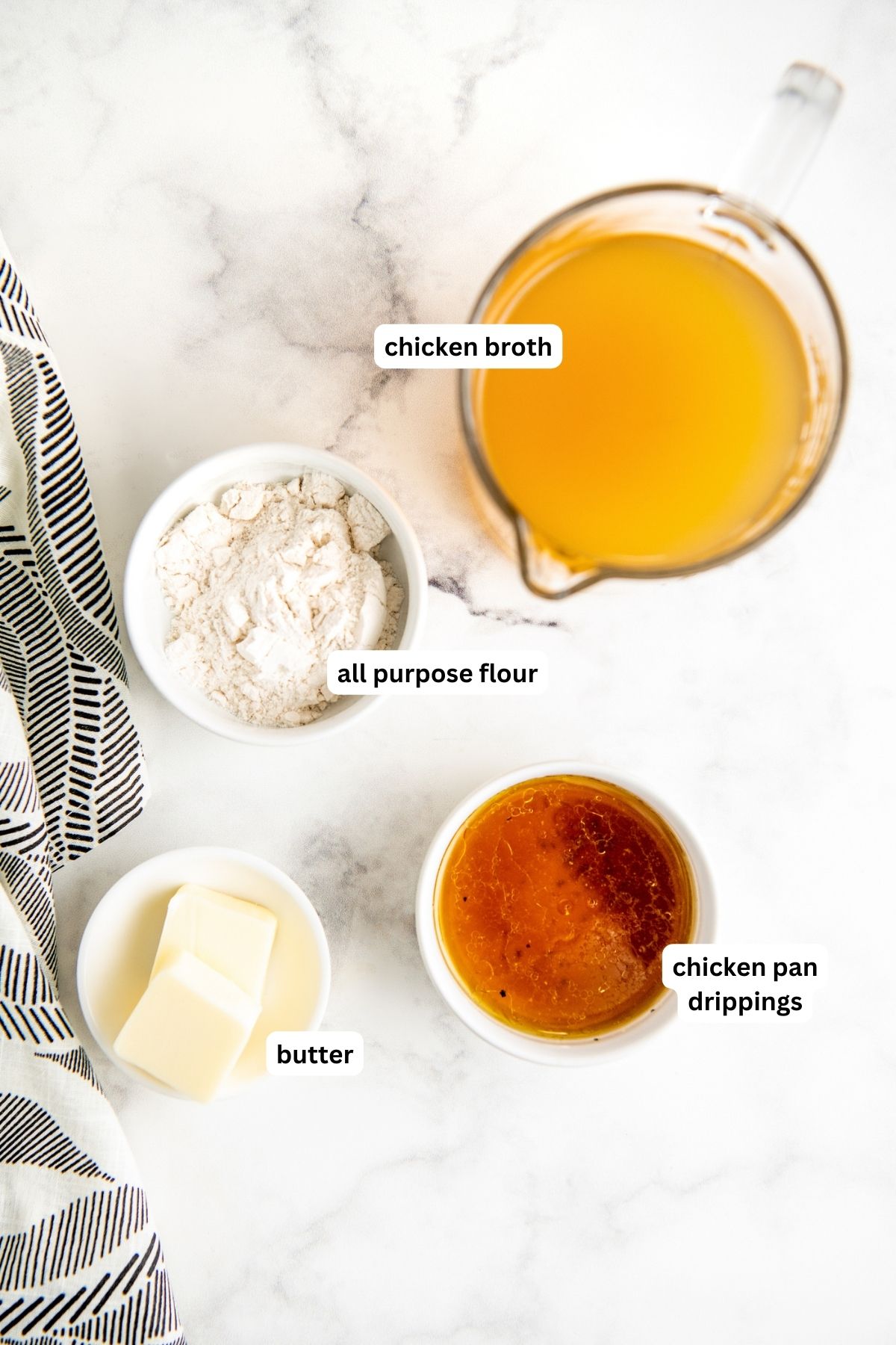 Ingredients for homemade chicken gravy recipe arranged in bowls, from top to bottom: chicken broth, flour, chicken pan drippings and butter.