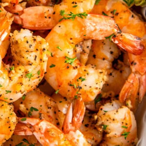 Juicy air fryer shrimp with garlic topped with fresh herbs.