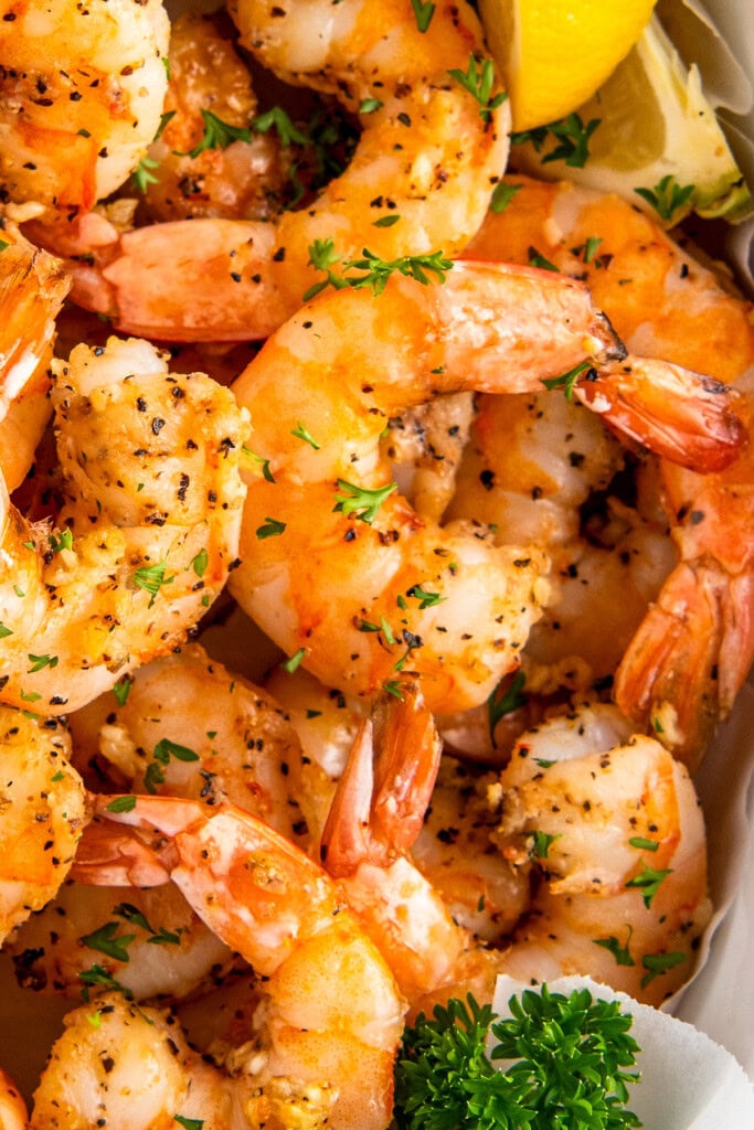 Juicy air fryer shrimp with garlic topped with fresh herbs.