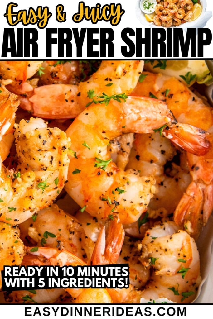 Air fryer shrimp in a bowl topped with fresh herbs and lemon wedges on the side.