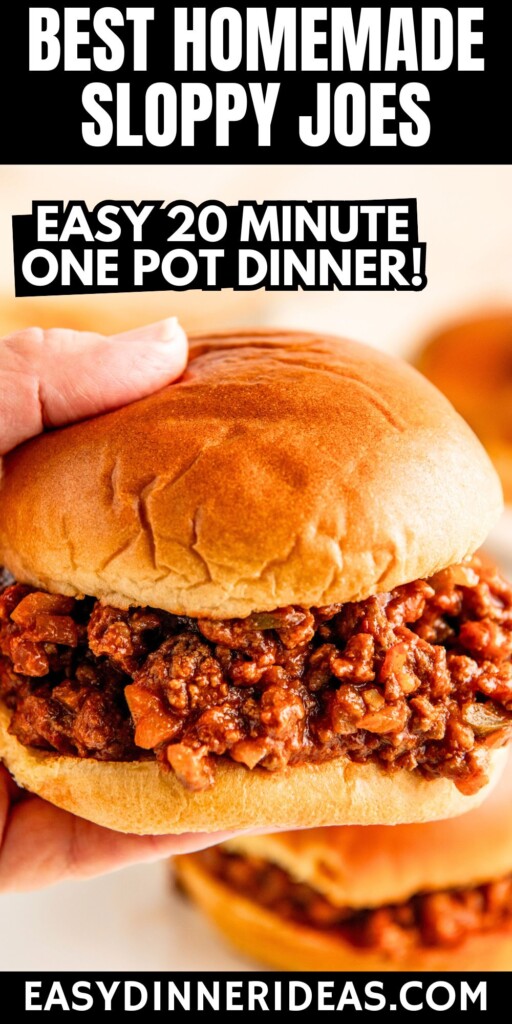 Homemade sloppy joes being served in hamburger buns with a hand lifting up one of the sandwiches off a platter.