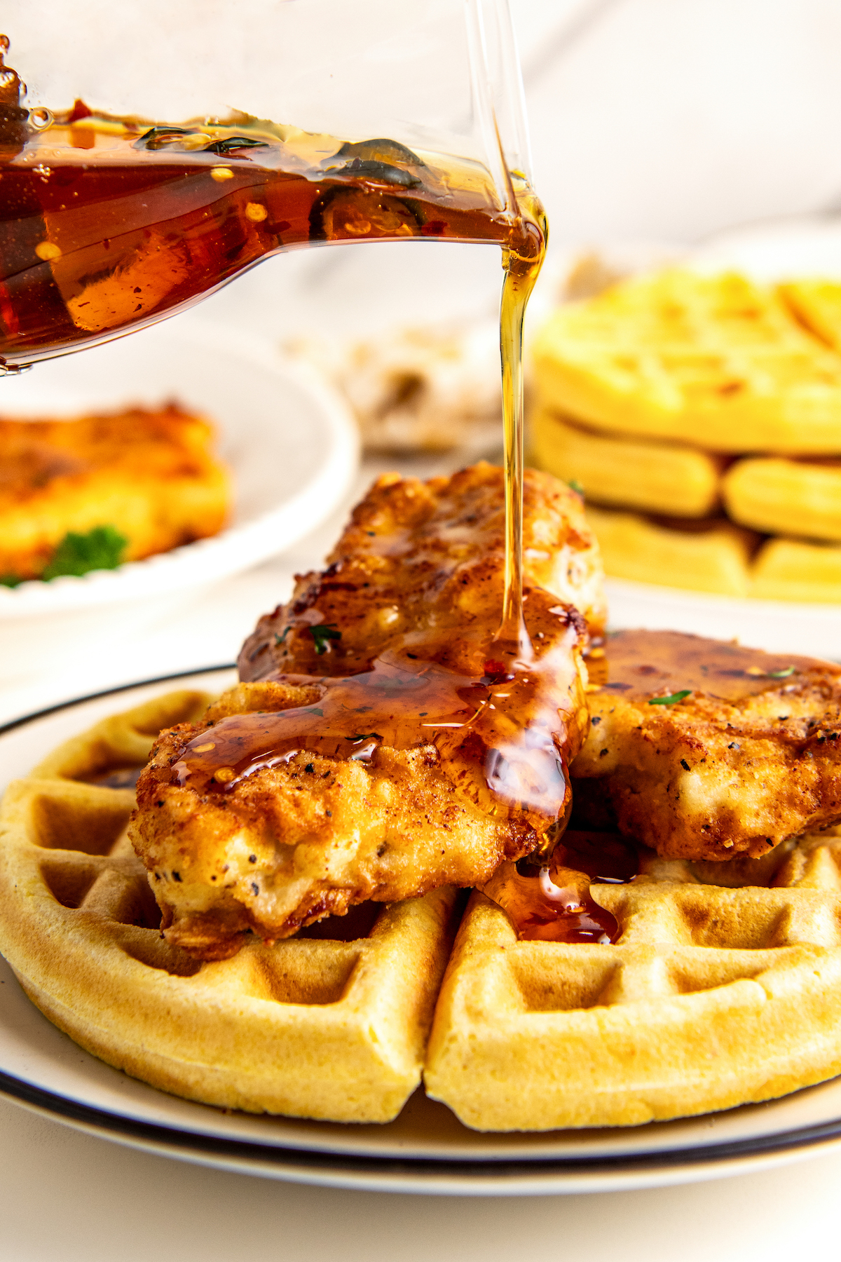 Pouring hot honey over the Southern chicken with waffles.