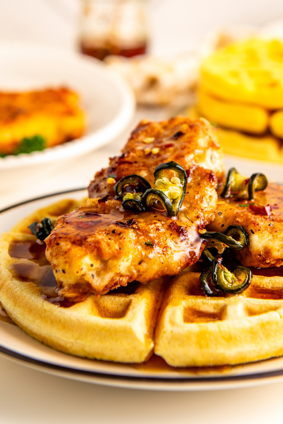 Freshly-made fried chicken and waffles with hot honey and tender candied jalapeños on top. 