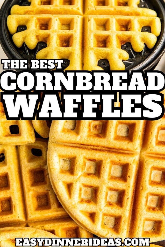 Fluffy cornbread waffles being cooked in a waffle iron and then stacked on top of each other on a baking tray.