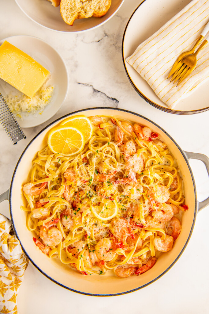 Pan filled with lemon garlic shrimp pasta garnished with fresh parsley.