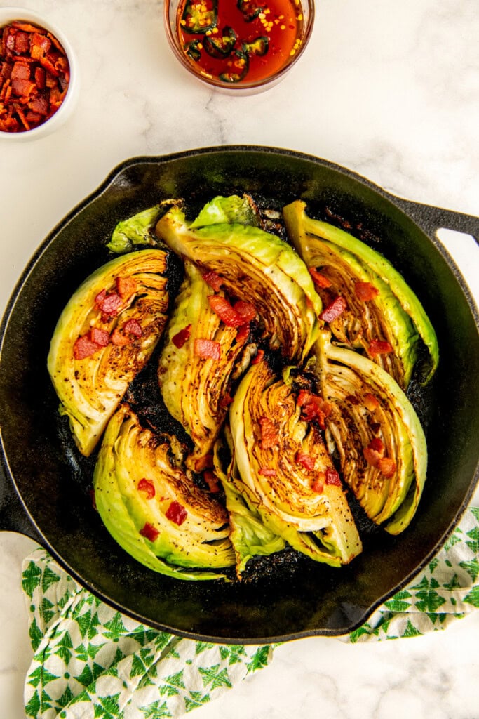 Fried cabbage in the skillet with smokey thick-cut bacon. 