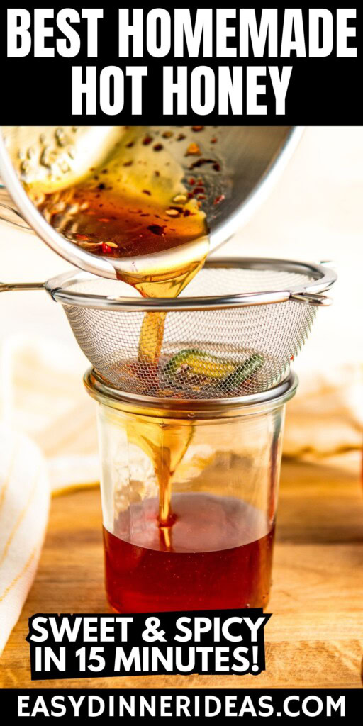 Hot honey sauce being strained through a fine mesh sieve into a jar.