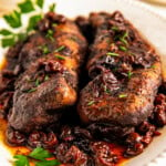 Two whole pieces of tenderloin covered in cherry-balsamic sauce.