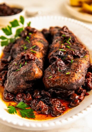 Two whole pieces of tenderloin covered in cherry-balsamic sauce.