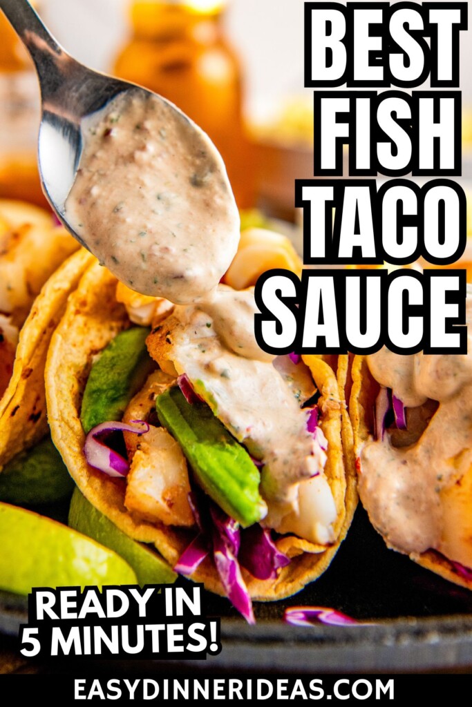 A spoon drizzling fish taco sauce on top of tacos.