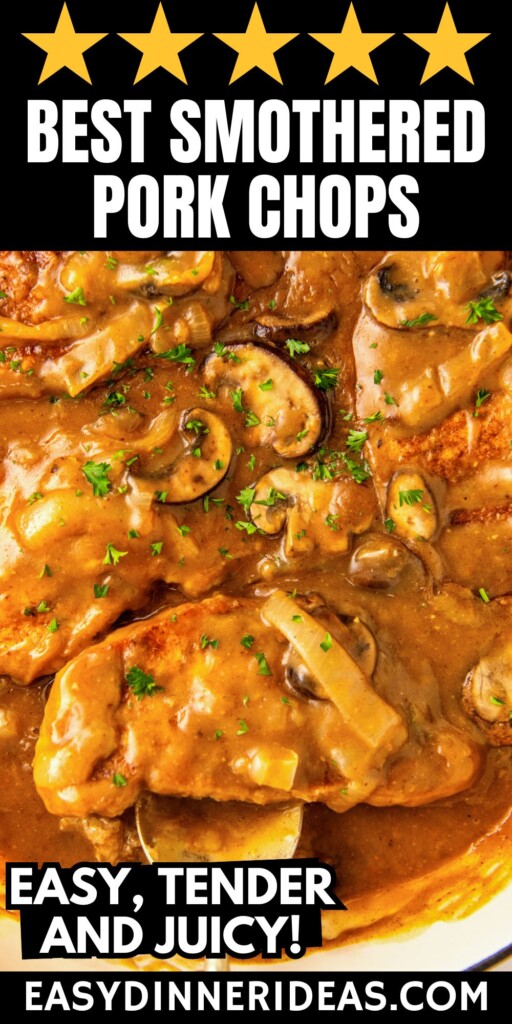 Smothered pork chops in mushroom gravy in a skillet topped with fresh herbs.