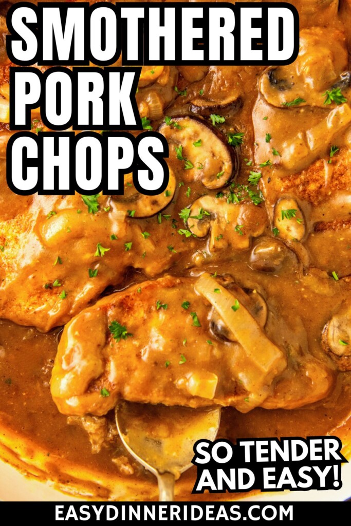 Smothered pork chops in gravy with a serving spoon scooping out a serving of pork chops.