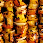 Close-up of pineapple chicken kabobs with peppers, onions, and sweet pineapple.