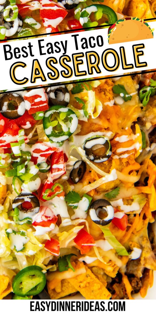 Easy taco casserole with fritos in a baking dish with fresh toppings and sour cream on top.