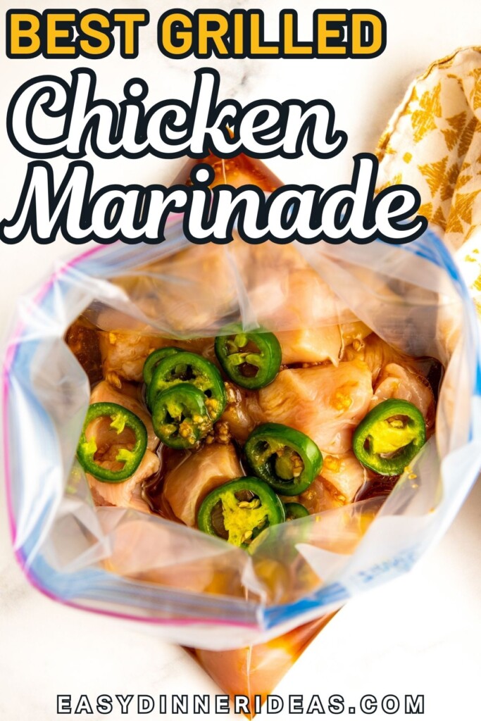 A large zip top bag is filled with raw chicken and spicy marinade.