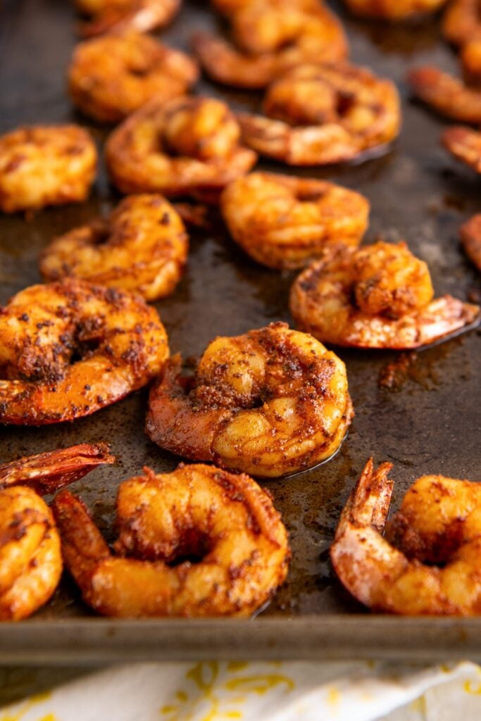 Blackened shrimp cooking in a skillet.