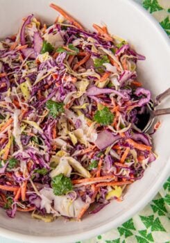 Fish taco slaw is tossed in a large mixing bowl.