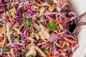 Fish taco slaw is tossed in a large mixing bowl.