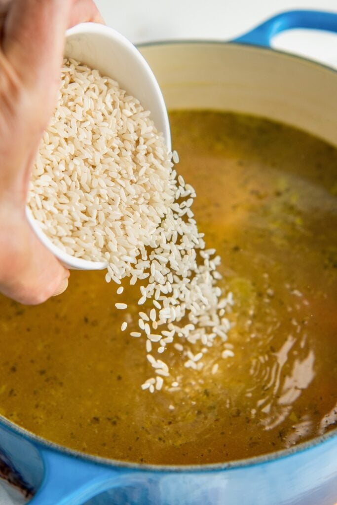 Rice is poured into the soup pot.