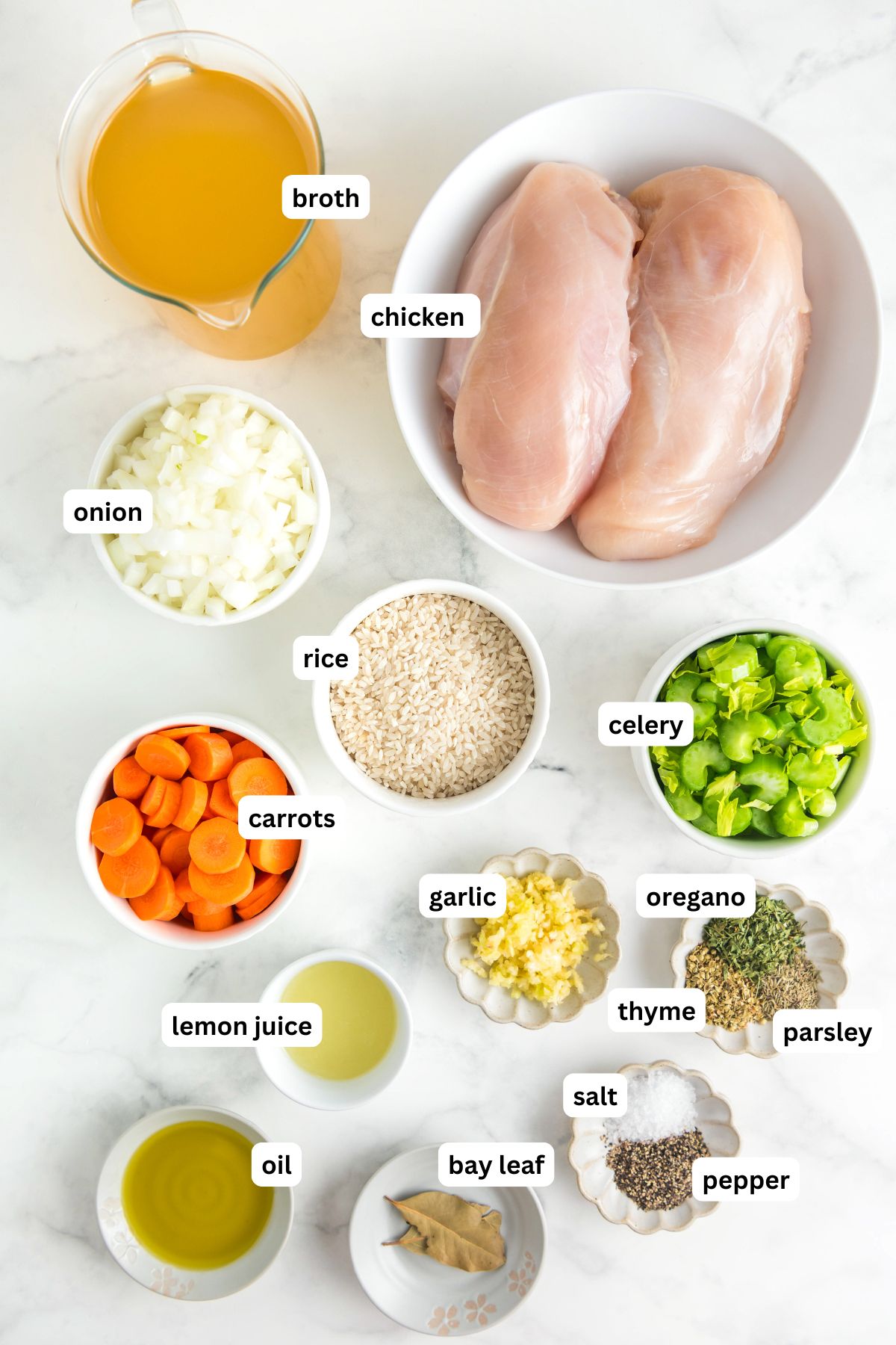 Ingredients for chicken lemon rice soup recipe in order from top to bottom: broth, chicken, onion, rice, carrots, celery, lemon juice, garlic, oregano, thyme, parsley, oil, bay leaf, salt, pepper.