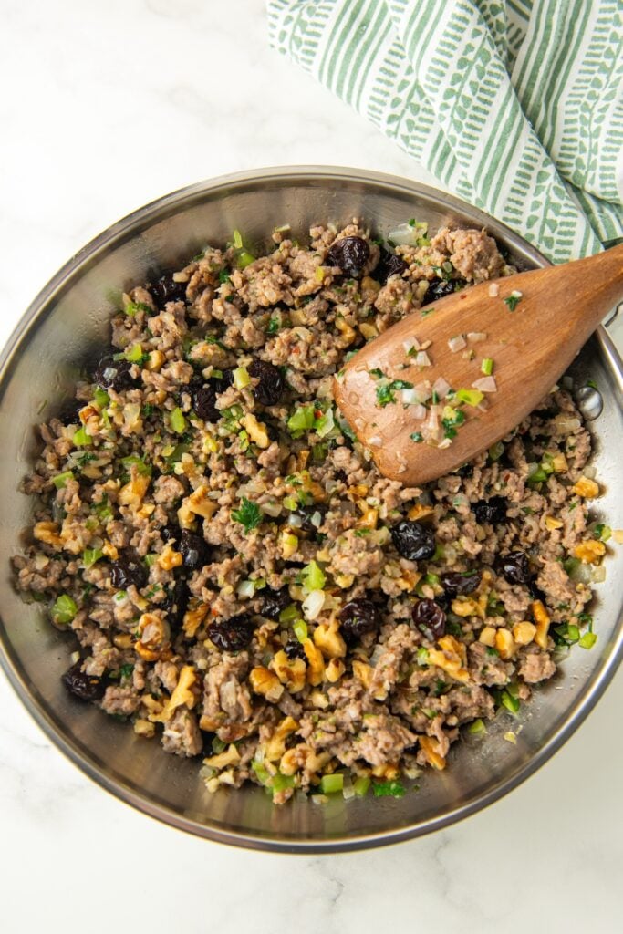 A ground sausage mixture cooking in a skillet.