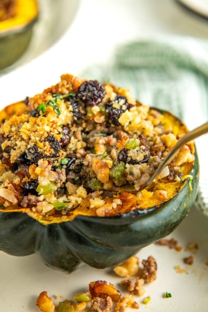 A fork is digging into a serving of stuffed squash.