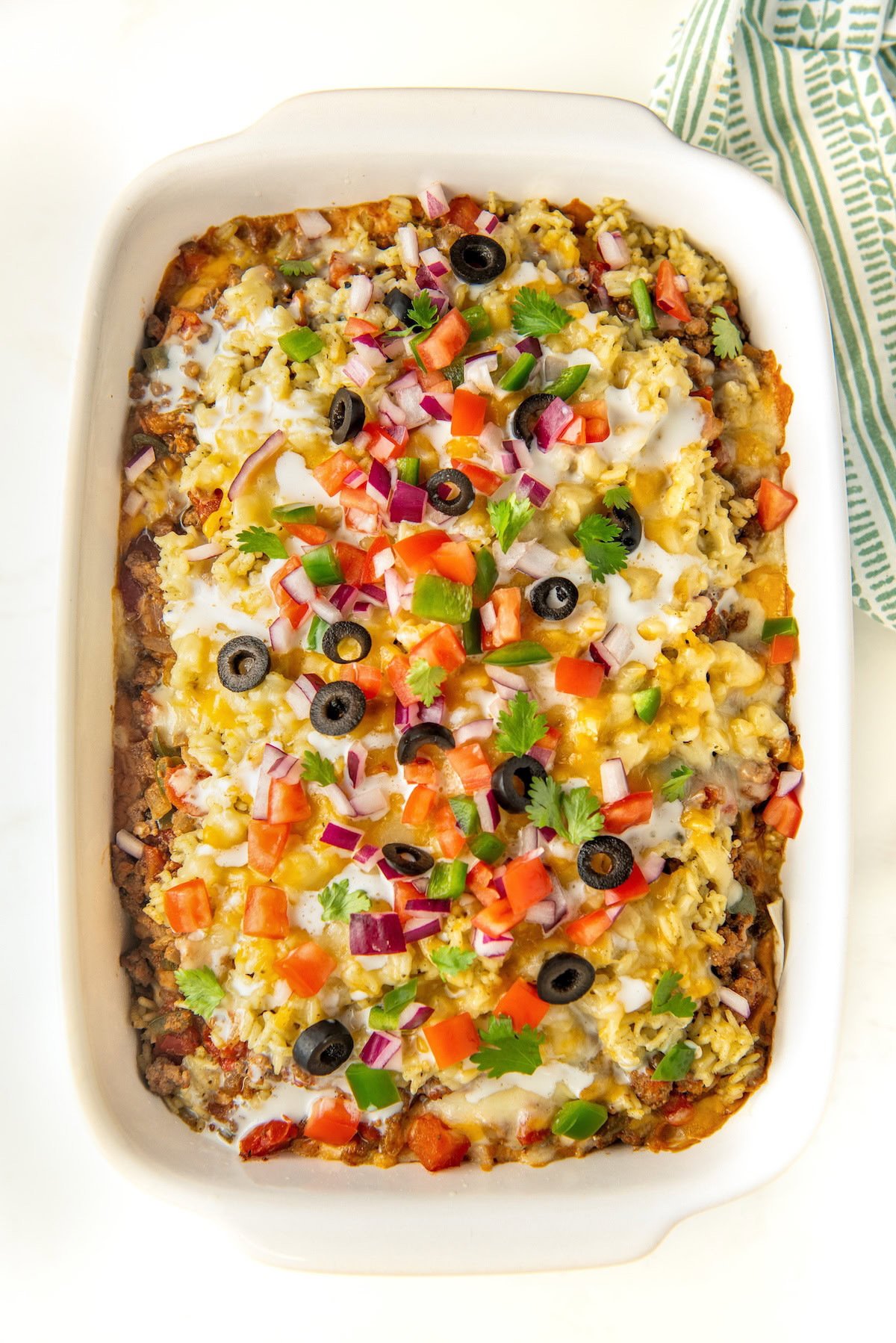 Cheesy baked burrito casserole fully garnished.