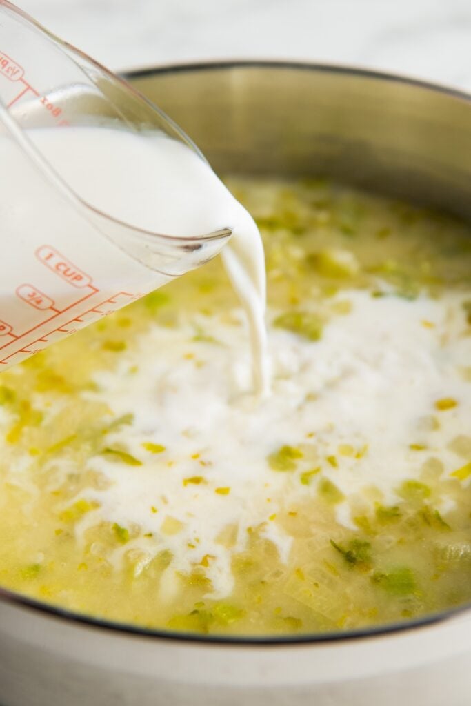 Milk is being poured into a skillet.