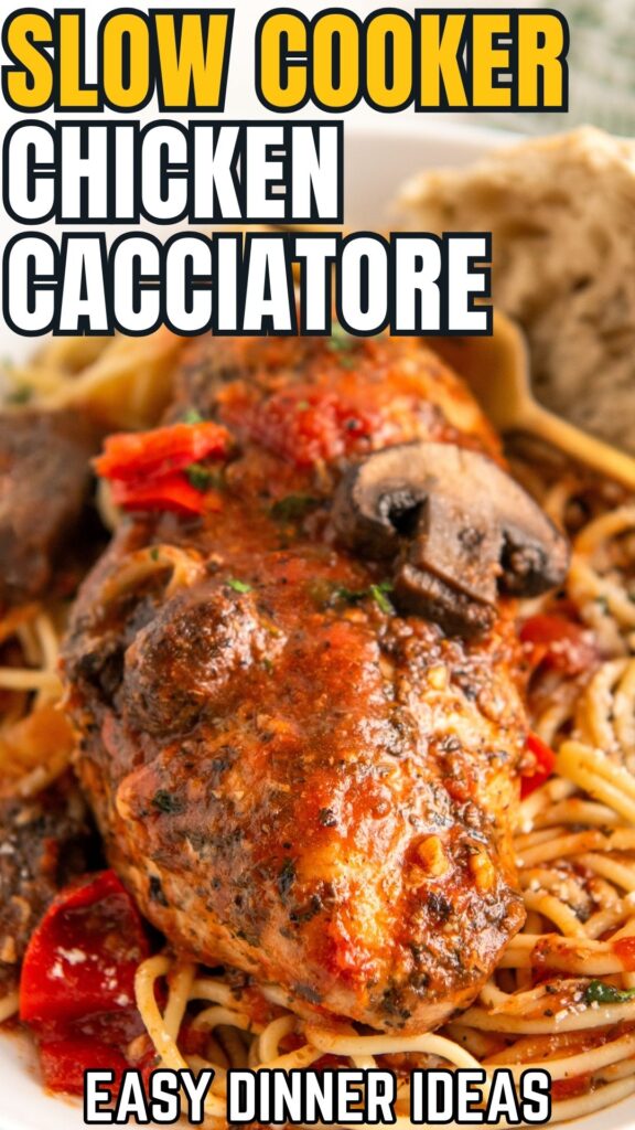 Slow cooker chicken cacciatore is presented on a serving of pasta.