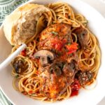 Italian chicken, vegetables, and pasta are plated together.