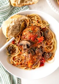 Italian chicken, vegetables, and pasta are plated together.