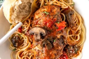 Italian chicken, vegetables, and pasta are plated together.