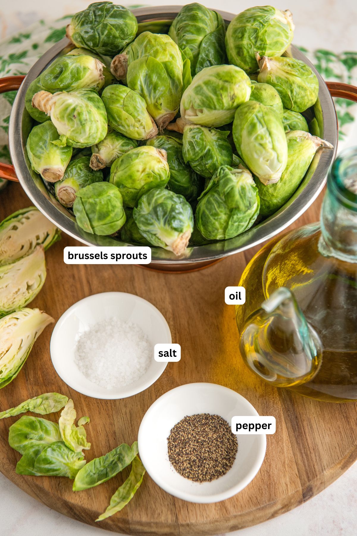 The ingredients for oven roasted brussels sprouts recipe in order from top to bottom: brussels sprouts, salt, oil, pepper.