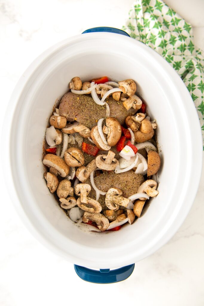 Ingredients for chicken cacciatore are in the crockpot.