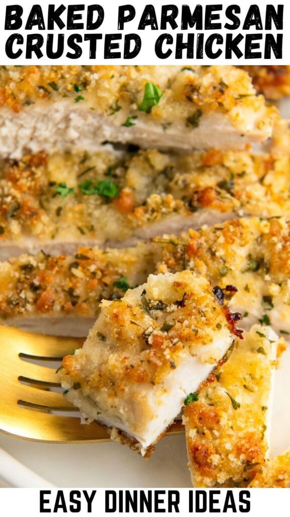 A bite sized portion of baked parmesan crusted chicken on a fork.