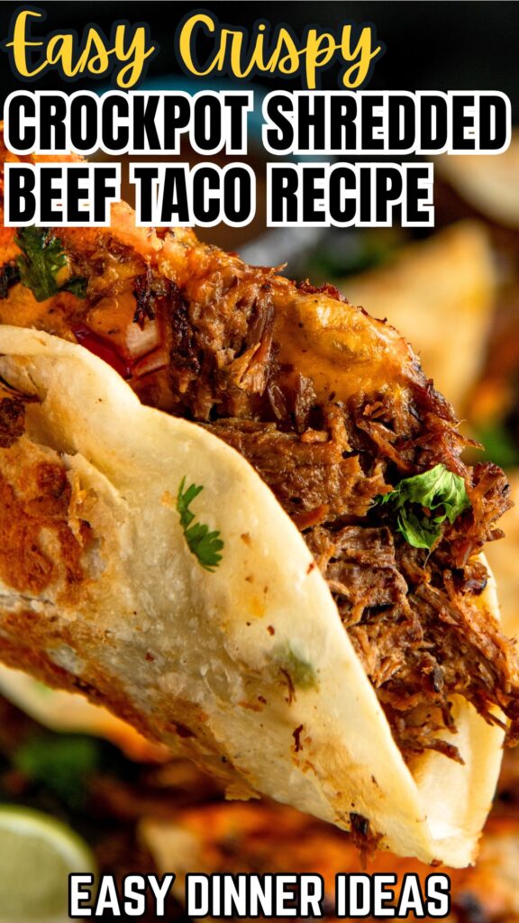 Close-up of a crispy crockpot shredded beef taco filled with juicy, seasoned meat and topped with fresh cilantro.