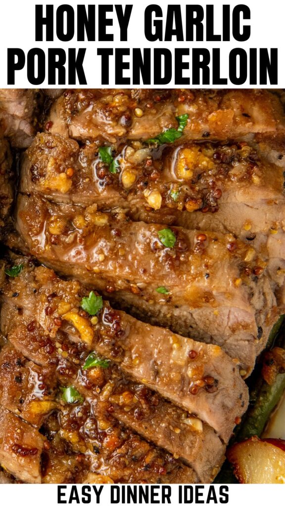 Close-up of juicy honey garlic roasted pork tenderloin slices, glazed with a rich, brown sauce speckled with herbs and garlic. The dish is garnished with fresh herbs.