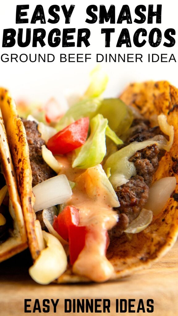 Close-up of a Big Mac smash burger taco with ground beef, diced tomatoes, onions, and lettuce in a toasted taco shell.