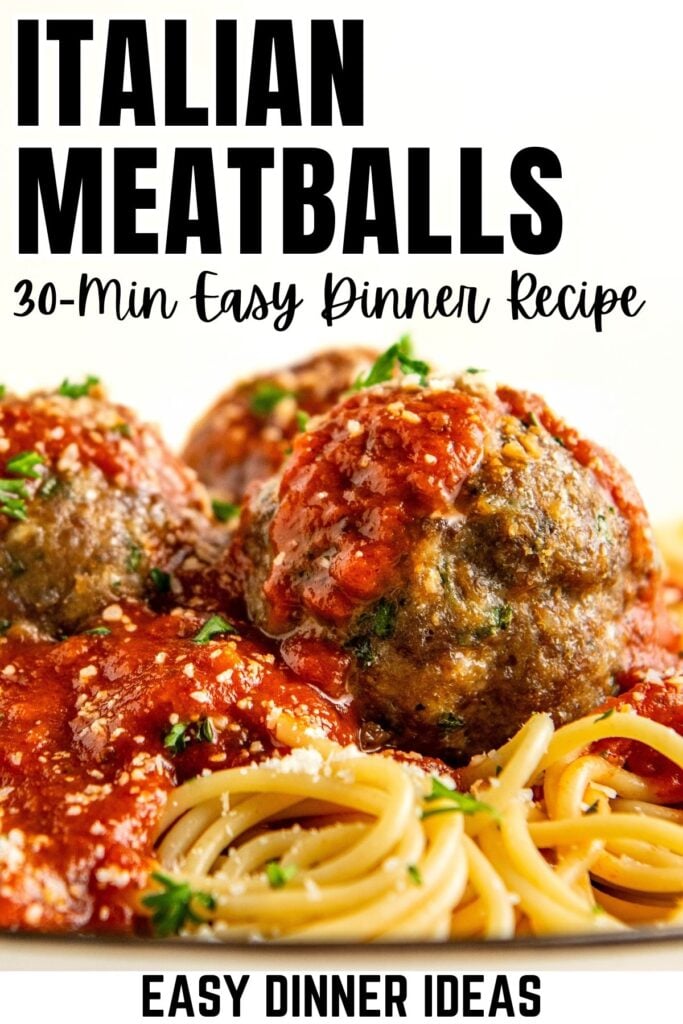 Close-up of spaghetti topped with three large meatballs covered in tomato sauce and herbs.