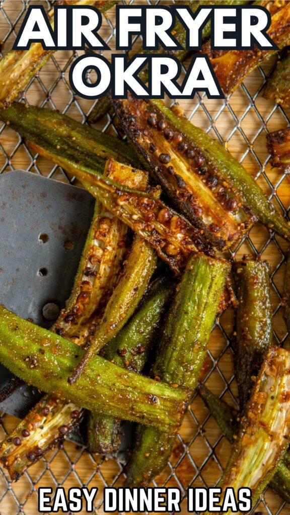 Close-up of crispy, seasoned okra pieces in an air fryer basket with a spatula.