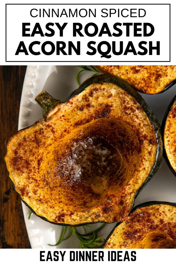 Close-up of roasted acorn squash halves sprinkled with cinnamon on a white plate.