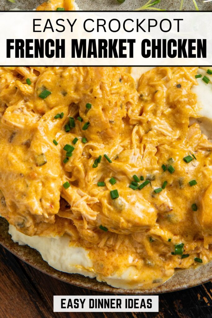 Close-up of creamy French market crockpot chicken with chopped chives, served over mashed potatoes on a plate.