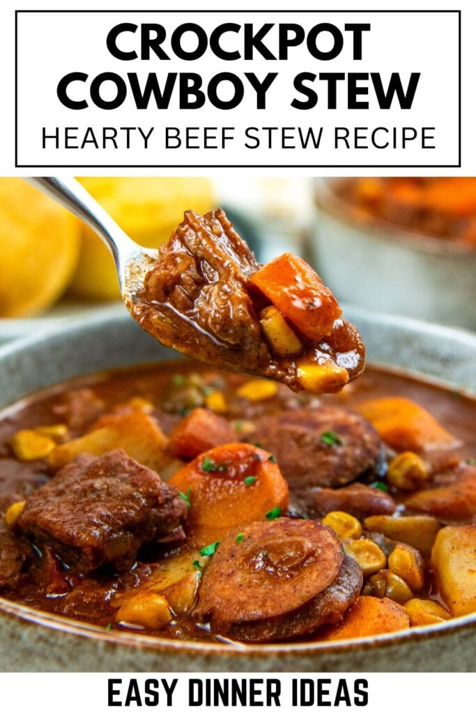 A spoonful of beef stew with chunks of beef, carrots, and beans hovers over a bowl filled with more cowboy stew.
