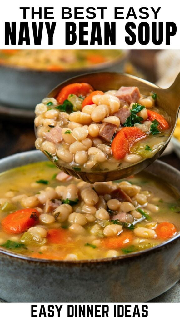 A ladle scoops hearty navy bean soup with ham, carrots, and herbs from a bowl.