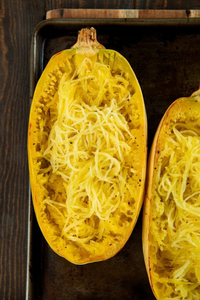 Stuffed spaghetti squash filled with a saucy ground meat mixture and gooey melted cheese. A hearty, low-carb comfort food with a veggie twist. A roasted spaghetti squash cut in half and pulled with a fork.