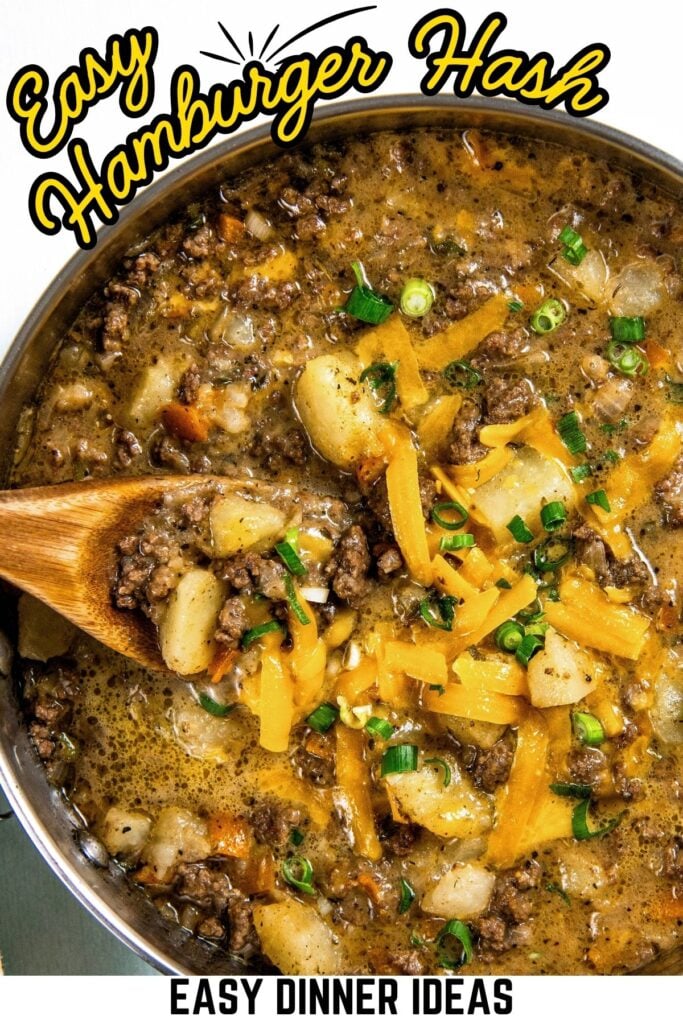 A pot of hamburger hash with ground beef, diced potatoes, melted cheese, and chopped green onions, stirred with a wooden spoon.