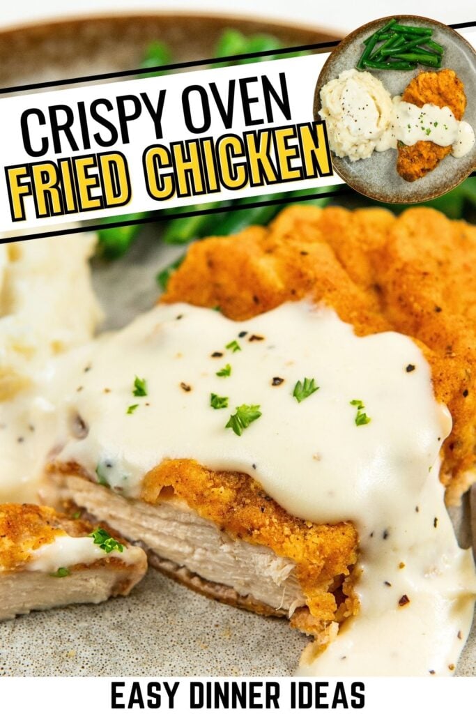 A close-up of crispy oven baked fried chicken topped with creamy white gravy and chopped parsley, served with green beans and mashed potatoes.